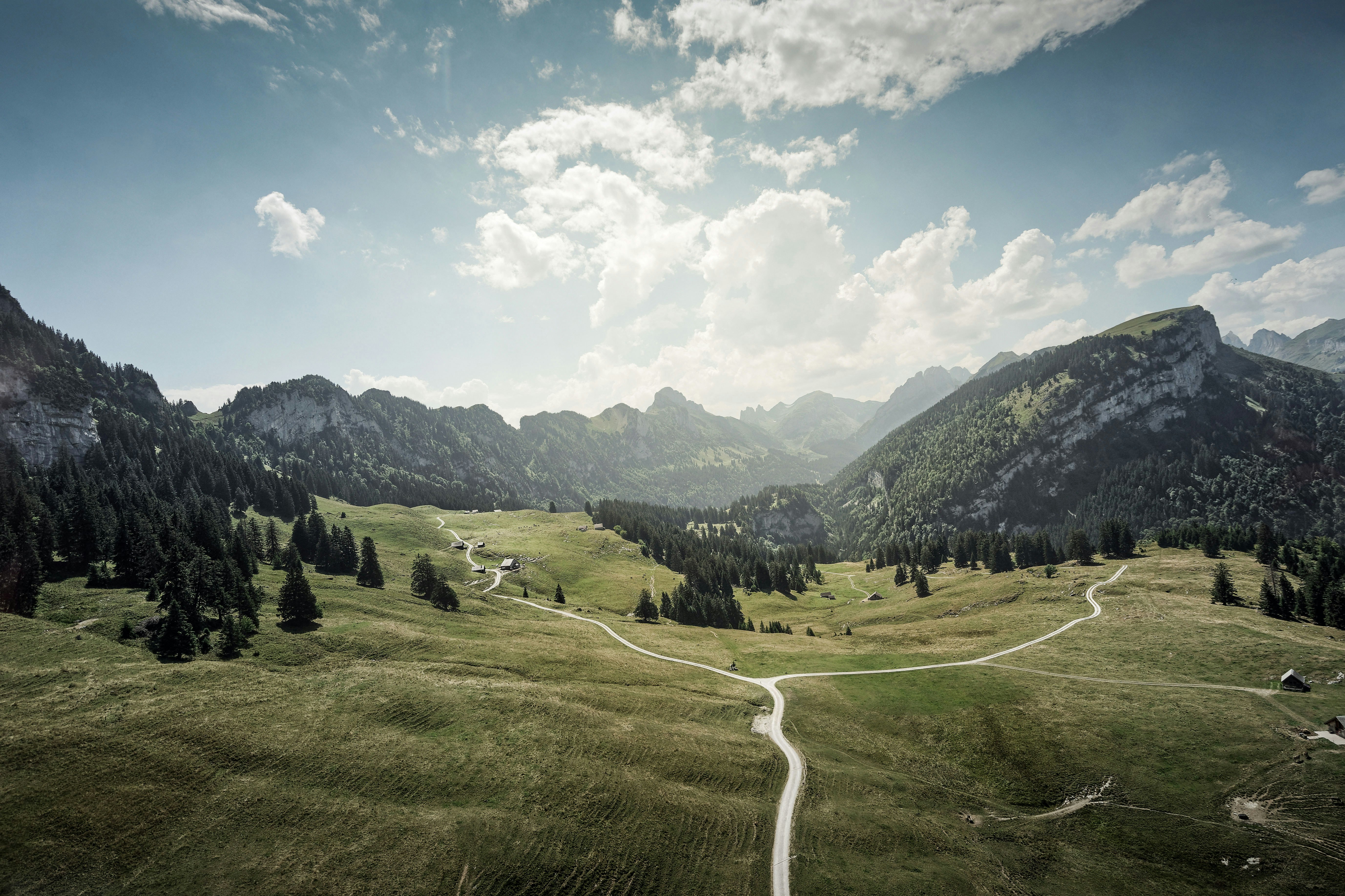 walkway by mountains during daytime